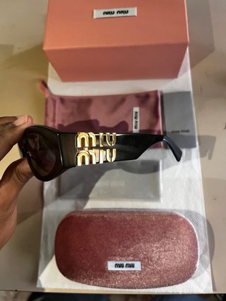 Occhiali da sole Miu Miu neri e oro