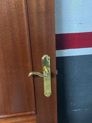 Puerta de madera con manilla dorada