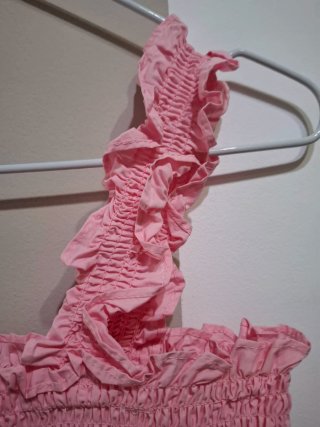 Top rosa elástico con volantes