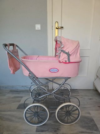 Carrito de muñeca rosa con capota