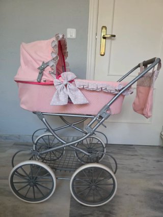 Carrito de muñeca rosa con capota