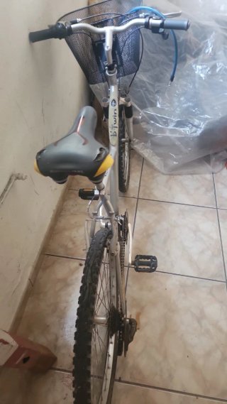 Bicicleta de montaña plateada con cesta