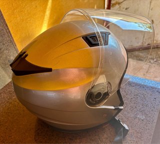 Casco de moto plateado con visera