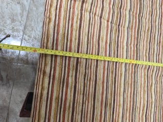 Sofá cama de tela beige y marrón