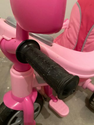 Triciclo infantil rosa con empujador