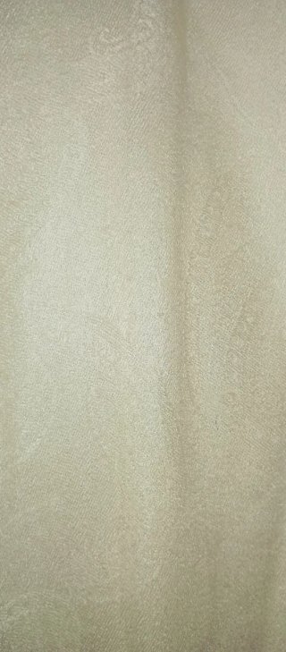 Pañuelo blanco roto con flecos.
