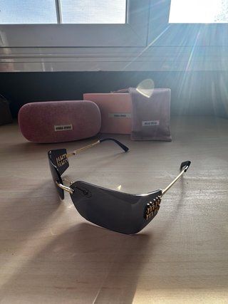 Gafas Miu Miu Cristal Oscuro Dorado