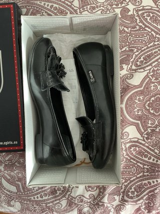 Mocasines negros con flecos y borlas