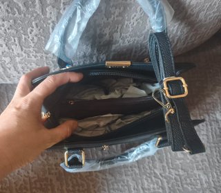Bolso negro con adornos dorados.