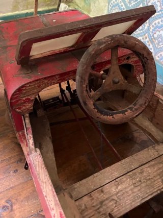 Coche de madera vintage a pedales rojo