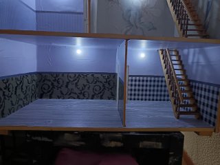 Casa de muñecas con ventanas naranjas