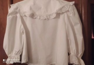 Blusa blanca con cuello volante y encaje