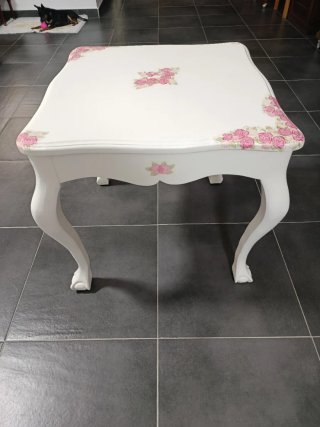 Mesa restaurada de madera blanca con flores rosas