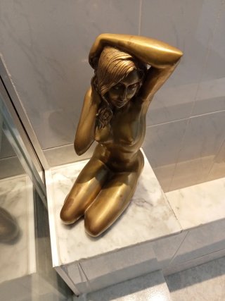 Escultura femenina de latón