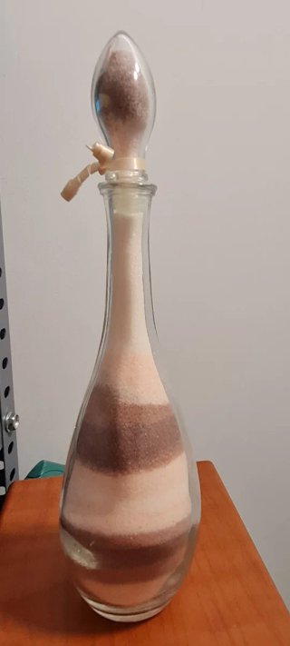 Botella de cristal decorativa con arena