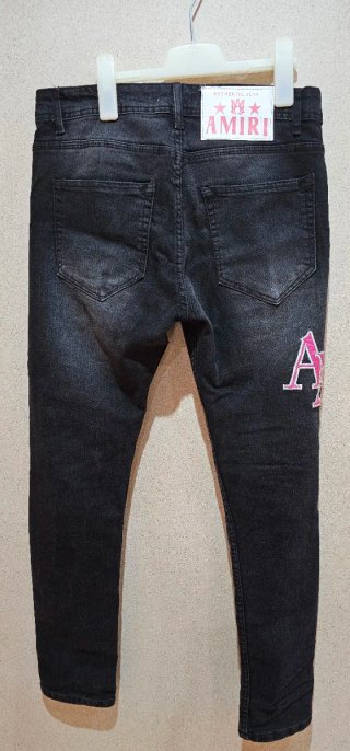Pantalones Amiri negros con detalles rosas unisex
