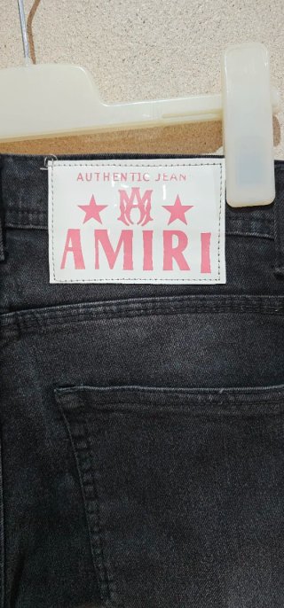 Pantalones Amiri negros con detalles rosas unisex
