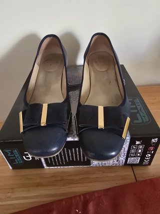 Zapatos planos azules con lazo dorado