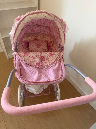 Carrito de bebé de juguete rosa