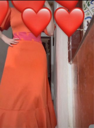 Traje de flamenca naranja y rosa