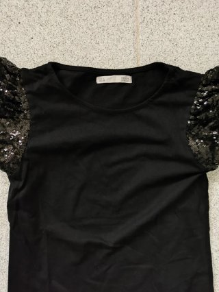 Blusa negra mujer lentejuelas mangas abullonadas.