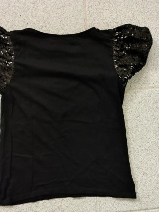 Blusa negra mujer lentejuelas mangas abullonadas.