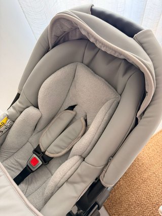 Carro de bebé con funda impermeable con maxicosi