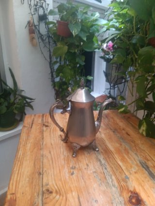 Tetera antigua de metal plateado