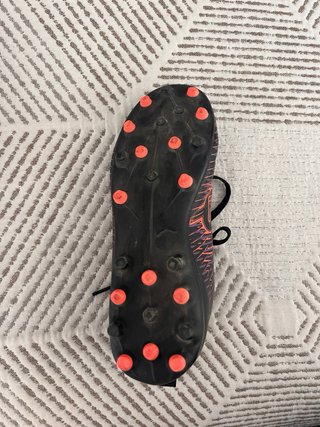 Botas de fútbol Puma negras y naranjas