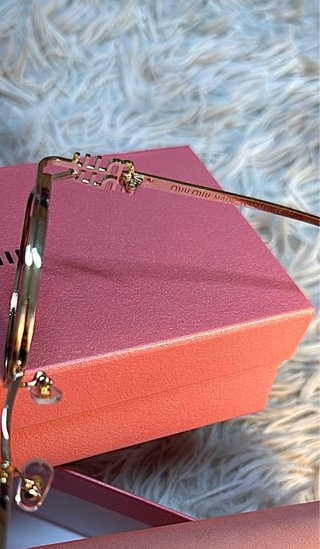 Gafas de sol Miu Miu negras y doradas