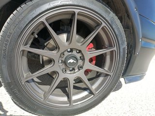 Llantas estilo japan racing con neumáticos.