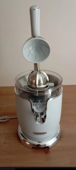 Exprimidor eléctrico blanco y cromado