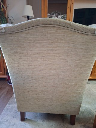 Dos sillones orejeros beige , con fino estampado.