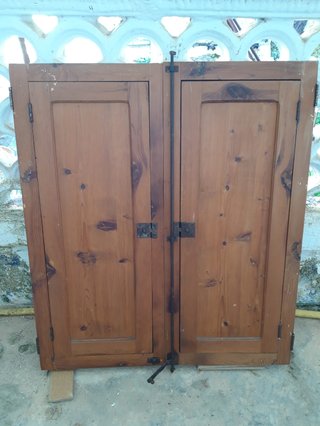 Ventana vidriera con portones de madera