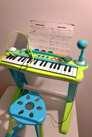 Piano de juguete con pie y asiento