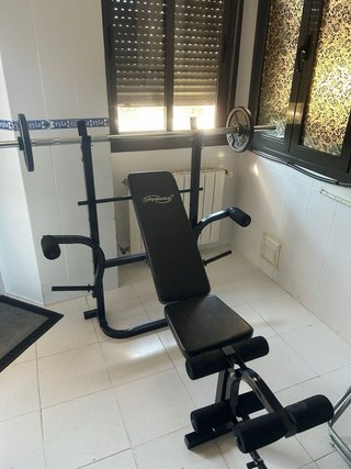 Banco de pesas con barra y discos