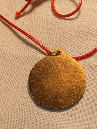 Medaglia dorata con cordino rosso