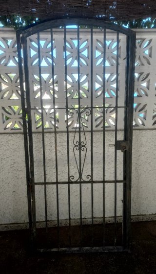 Puerta de forja con un diseño elegante y curvo en