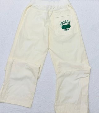 Pantalón chándal Nike beige con logo verde Talla S