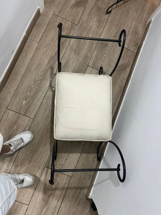 Banqueta de forja negra y cojín blanco