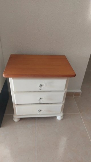 Cómoda de madera con espejo y dos mesitas.