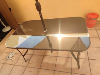 Mesa de cristal y sombrilla beige