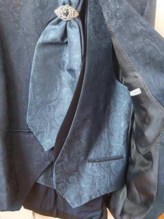 Traje de novio azul con chaleco y corbata y camisa