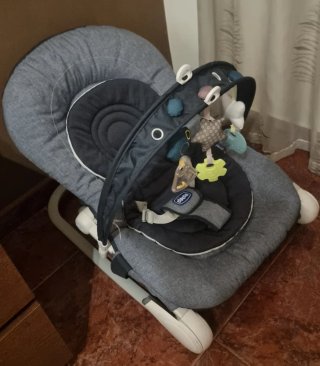 Mecedora Chicco gris con juguetes