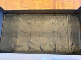 Cuna de viaje gris con funda y colchón