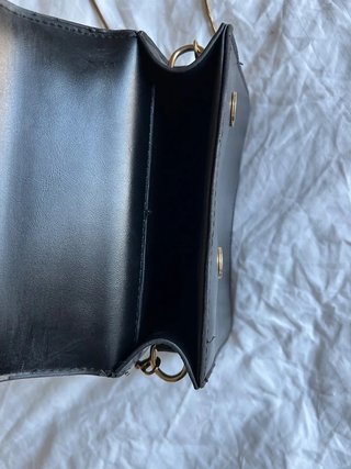 Bolso negro con asa y cadena dorada