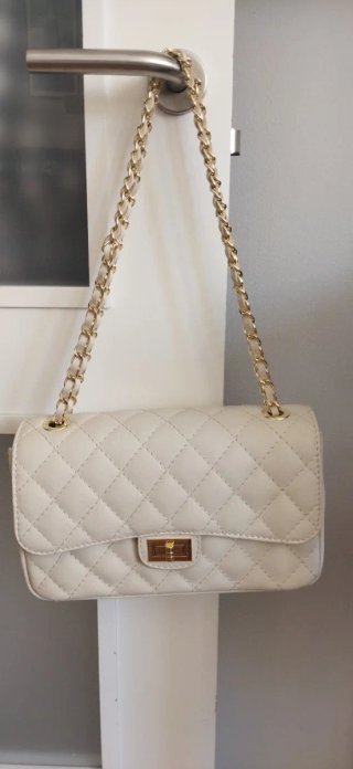 Bolso de mano beige con cadena dorada