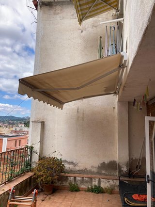 Toldo terraza retráctil beige y gris