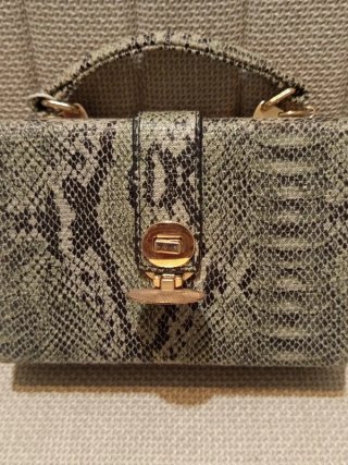 Bolso rígido con llamativo efecto piel serpiente