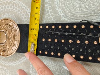 Cinturón negro con tachuelas doradas y hebilla